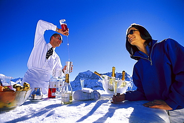 People at a bar made of snow under blue sky, Palmenalpe, Lech, Vorarlberg, Austria, Europe