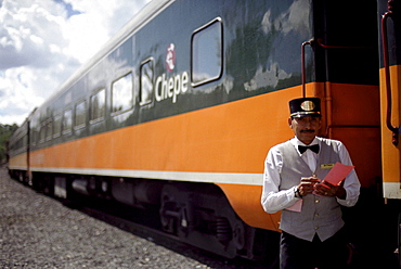 A conductor standing in front of a train, Ferrocarril Chihuahua al Pacifico, Chihuahua express, Mexico, America