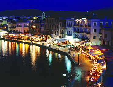 Illuminated Venetian Harbour at night with restaurants, Chania, Crete, Greece