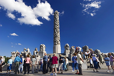 Tourist group on Monolith Plateau, granite sculptures by Gustav Vigeland in Vigeland Park, Oslo, Norway