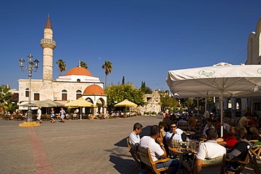 People sitting in a pavement cafe near Defterdar-Mosque at Platia Eleftherias, Kos-Town, Kos, Greece