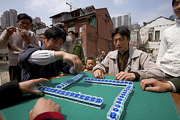 demolition in old town, Lao Xi Men, redevelopment area, living amongst demolished houses, migrant worker, living in demolished houses and self built shacks, slum, Living amongst ruins, playing majong