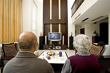 old couple in modern villa, old couple with big TV screen, living room, luxury apartment, western Shanghai, interieur, private house, interior, new suburb