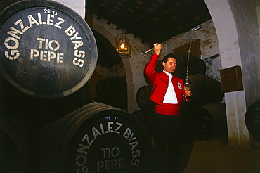 Man in traditional costume filling a glass, Bodegas Gonzales Byass, Sherry, Jerez de la Frontera, Province Cadiz, Andalusia, Spain, Andalusia, Spain, Europe