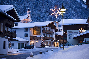 View along a street with christmas decoration in the evening, Flachau (927 m), Salzburger Land, Austria