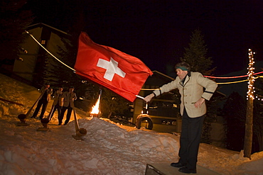 A flagswinger and swiss horn players at night, Saas-Fee, Valais, Switzerland