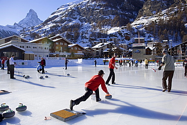 People curling on a rink, Matterhorn in background, Zermatt, Valais, Switzerland