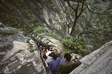 Tourists climbing downwards, stone steps and chains below North Peak, Taoist mountain, Hua Shan, Shaanxi province, Taoist mountain, China, Asia