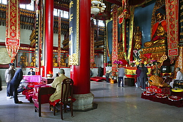 People at prayer hall of the Wangfo Monastery, Jiuhuashan, Anhui province, China, Asia