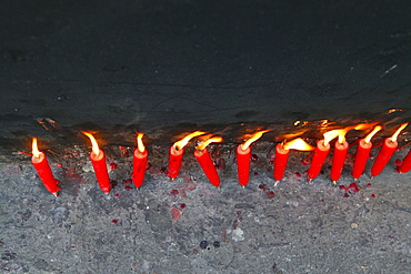 Red candles burning in a line, Island of Putuo Shan, Zhejiang Province, China, Asia