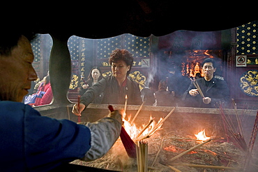 Pilgrims and tourists praying at Puji Si Temple, Buddhist Island of Putuo Shan near Shanghai, Zhejiang Province, China