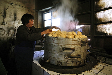 Woman making steamed buns inside the kitchen of Fawang Monastery, Shaolin monastery, known for Shaolin boxing, Taoist Buddhist mountain, Song Shan, Henan province, China