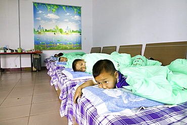 Kung Fu training at kindergarten age, at one of the many new Kung Fu schools in Dengfeng, very young pupils in the dormitory at one of the new Kung Fu Schools in Dengfeng, near Shaolin, Song Shan, Henan province, China, Asia