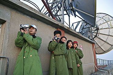 Tourists at the summit of Mount Tai filming the sunset, military coats can be rented out, Tai Shan, Shandong province, World Heritage, UNESCO, China