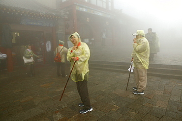 Pilgrims, tourists in rain capes at the entrance to Bixia Si temple, Mount Tai, Tai Shan, Shandong province, World Heritage, UNESCO, China