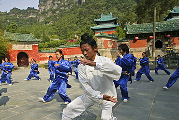 monk meditating in lotus position, sunrise, Golden Hall, Jindian Gong, peak 1613 metres high, Wudang Shan, Taoist mountain, Hubei province, Wudangshan, Mount Wudang, UNESCO world cultural heritage site, birthplace of Tai chi, China, Asia