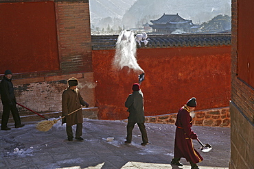 Monks clearing snow, high walls of monastery, Xiantong Monastery, Wutai Shan, Five Terrace Mountain, Buddhist Centre, town of Taihuai, Shanxi province, China