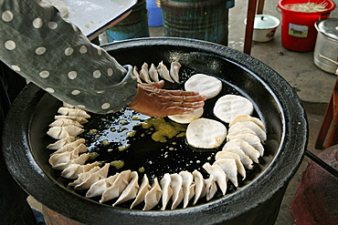 Jiaozi, cook turning fried Chinese ravioli, Chinese food, China