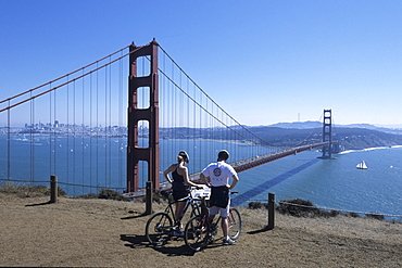 Cyclists Overlooking Golden Gate Bridge & San Francisco Bay, San Francisco, California, USA