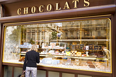 Woman standing at shop window of Spruengli (famous chocolate confectionery), Bahnhof Strasse, Zurich, Canton Zurich, Switzerland