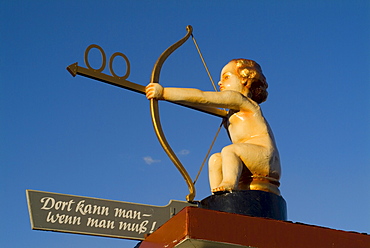 Angel shows direction to Bathroom at Oktoberfest, Munich, Bavaria, Germany