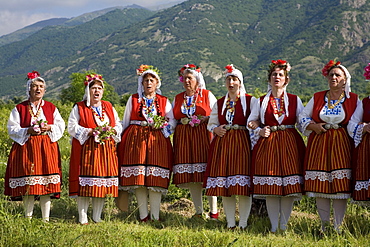 Singing women in traditional costumes at Rose Festival, Karlovo, Bulgaria, Europe