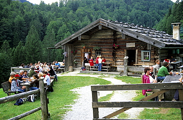 hikers having a break at alpine hut Harbachalm, Chiemgau, Upper Bavaria, Bavaria, Germany