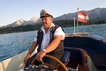 Skipper of a taxi boat service to the Inselhotel Faakersee, Lake Faak, Carinthia, Austria