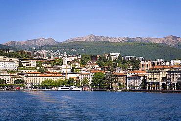 View over Lake Lugano to Lugano with mountains in background, Ticino, Switzerland