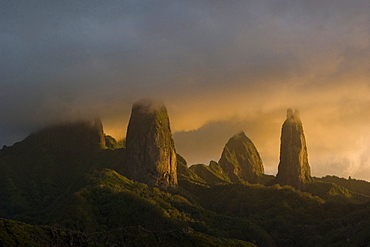 Mountain peaks of Ua Pou under cloud cover in the evening light, Marquesas, Polynesia, Oceania