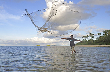 Fiherman throwing out fishnet, Fafa Island Resort, Tonga, South Seas