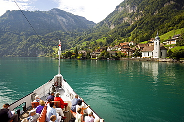 Passengers sitting on deck of a paddle wheel steamer, arriving Bauen, Lake Urnersee, part of Lake Lucerne, Bauen, Canton of Uri, Switzerland