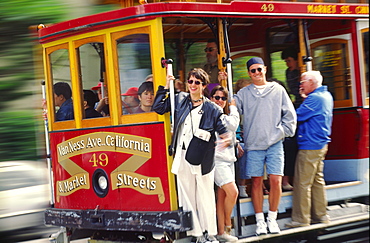 California San Francisco cable car tourists in full speed