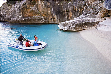 Tourists in rubber boat at Golfo di Orosei, Cala Goloritze, Sardinia, Italy