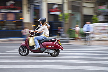 young woman, scooter, road from Valencia city Spain