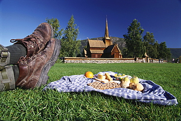 Man enjoying a Norwegan picknick at a church, Lom, Oppland, Norway