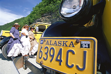 Three female drivers of tour buses in traditional dress, Skagway, Alaska, USA