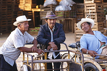 Three local men with transport cycles, Oxkutzca Market, Yucatan, Mexico