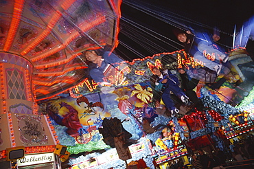 People on a swing carousel, chair-o-plane at the Octoberfest, Munich, Bavaria, Germanys