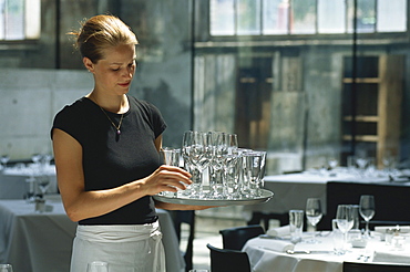 A waitress carrying glasses in Restaurant Lasalle, Zurich, Switzerland