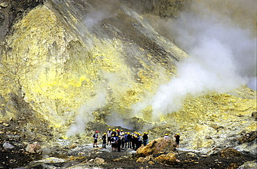 Tourists visiting sulphur fomaroles on White Island, North Island, New Zealand