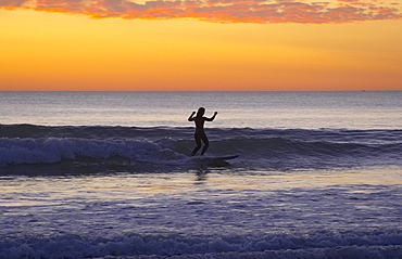 Evening with surf-riding woman at the beach of Carcans Plage, dept Gironde, France, Europe