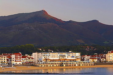 At sunset in the seaside resort St. Jean de Luz with Casino and view to La Rhune, Cote des Basques, dept PyrÃˆnÃˆes-Atlantiques, France, Europe