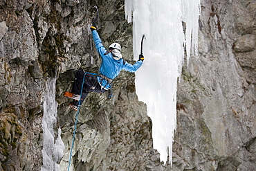 Iceclimbing in Pontresina, a man climbing a frozen waterfall, Pontresina, Grisons, Switzerland