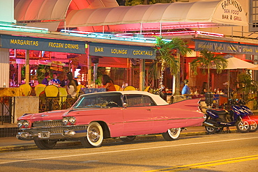 A vintage car on Collins Avenue in the evening, Miami Beach, Florida, USA