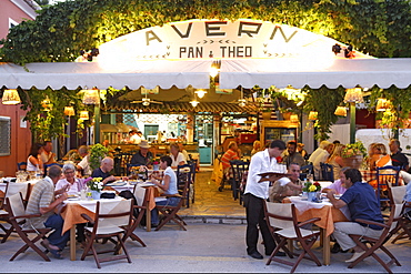 People sitting in a tavern at the harbour of Gaios, Ionian Islands, Greece