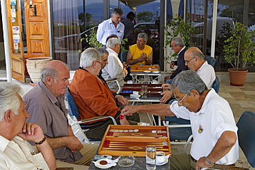 Mature men playing backgammon in a cafe, Corfu, Ionian Islands, Greece