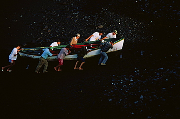 Fishermen shifting boat onto the volcanic beach, Punta de Fuencaliente, La Palma, Canary Islands, Atlantic Ocean, Spain