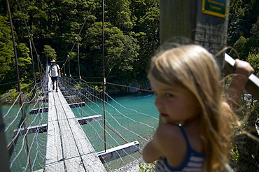 Girl on hanging bridge, track to Blue Pools, east of Haast Pass, Southern Alps, South Island, New Zealand