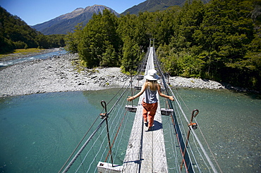 Girl on hanging bridge, track to Blue Pools, east of Haast Pass, Southern Alps, South Island, New Zealand